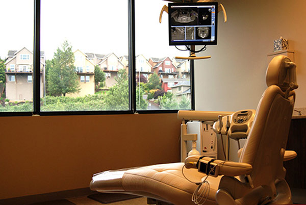 Dental exam chair facing window at Fusion Dental Specialists in Happy Valley, OR.