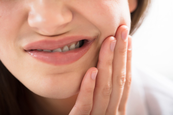 Woman with dental pain due to gum disease.