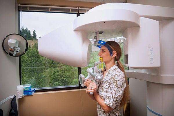 Woman using advanced dental technology at Fusion Dental Specialists in Happy Valley, OR.