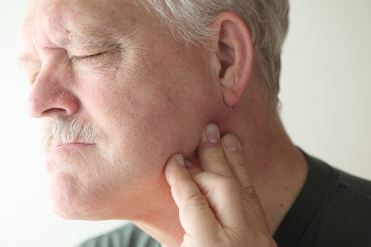 Man in pain with TMJ, at Fusion Dental Specialists in Happy Valley, OR.