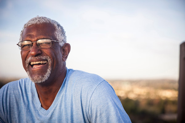 Man sitting outside and smiling, in Happy Valley, OR.