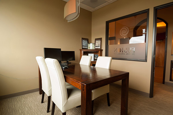 Desk with chairs in office room at Fusion Dental Specialists in Happy Valley, OR.