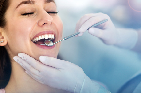 Woman getting a dental exam, at Fusion Dental Specialists in Happy Valley, OR.