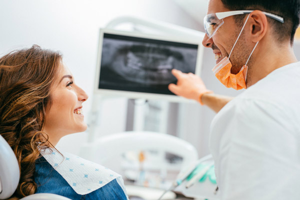 Dentist explaining an xray to a woman patient