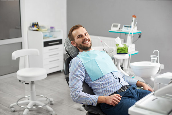 A smiling man in a dental chair, at Fusion Dental Specialists in Happy Valley, OR. 